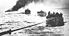 Den norske handelsflåtens innsats under krigen 1940-45. 'Columbus ' er torpedert og står i brann, og mannskapet er i livbåter på vei mot 'Tuscaloosa' som tar dem om bord.